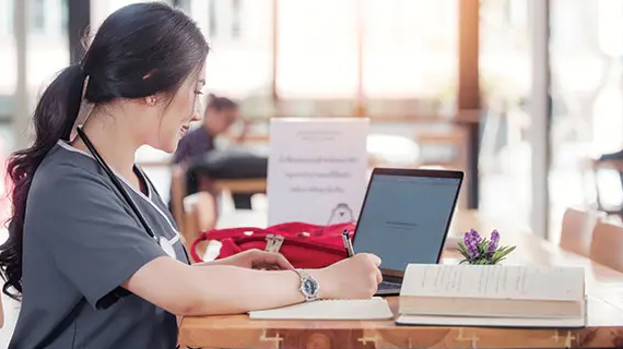 nurse writing in book