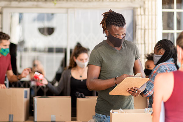 Man filling out form on clipboard